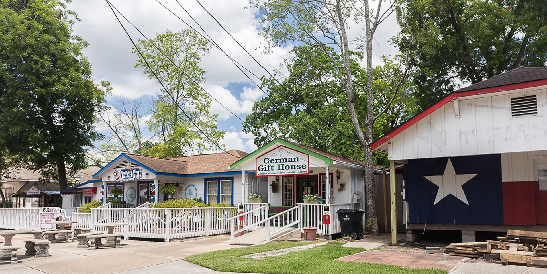 Historic storefronts and mature trees in Old Town Spring, Texas