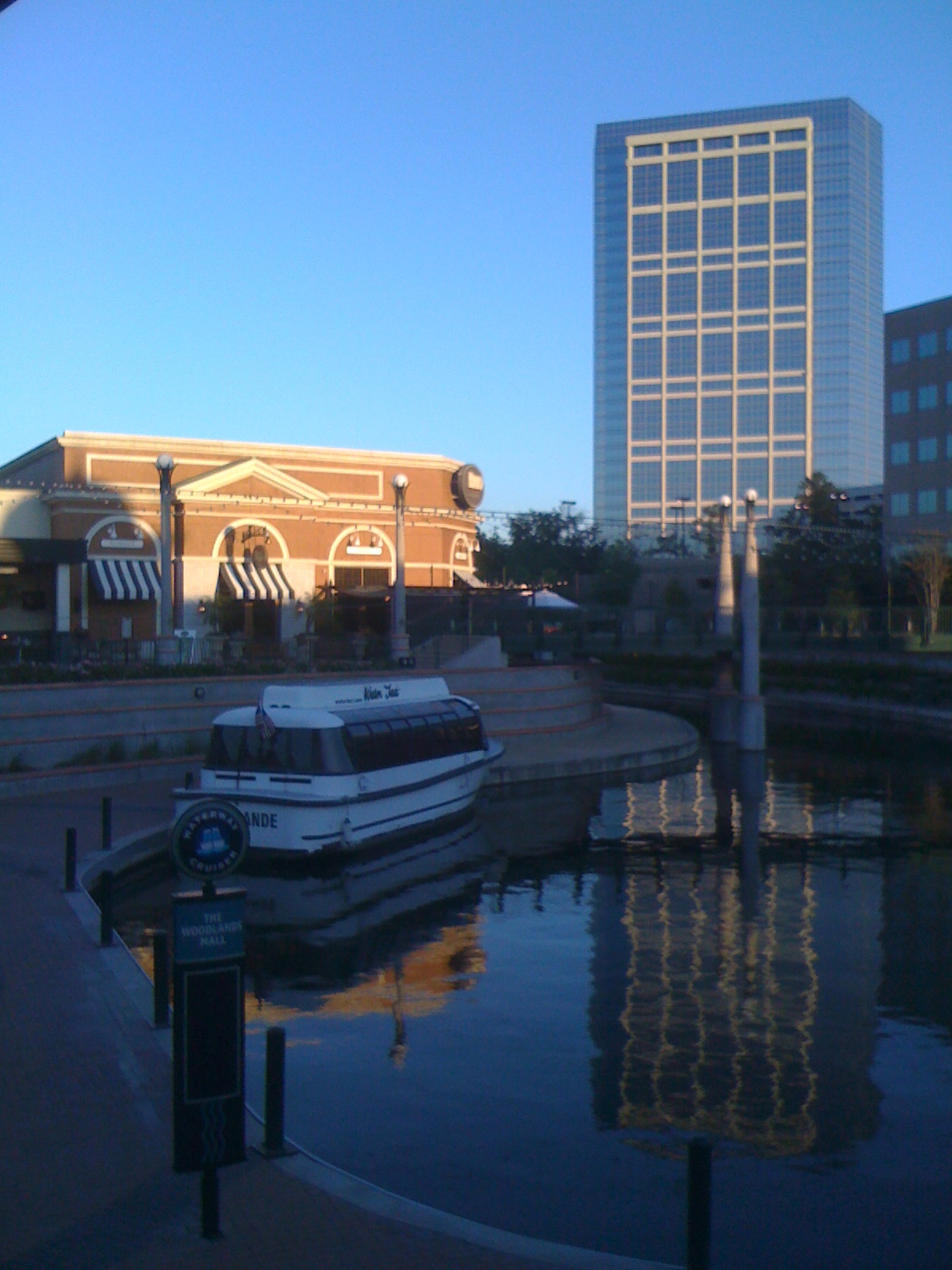 Water taxi and buildings along The Woodlands Waterway
