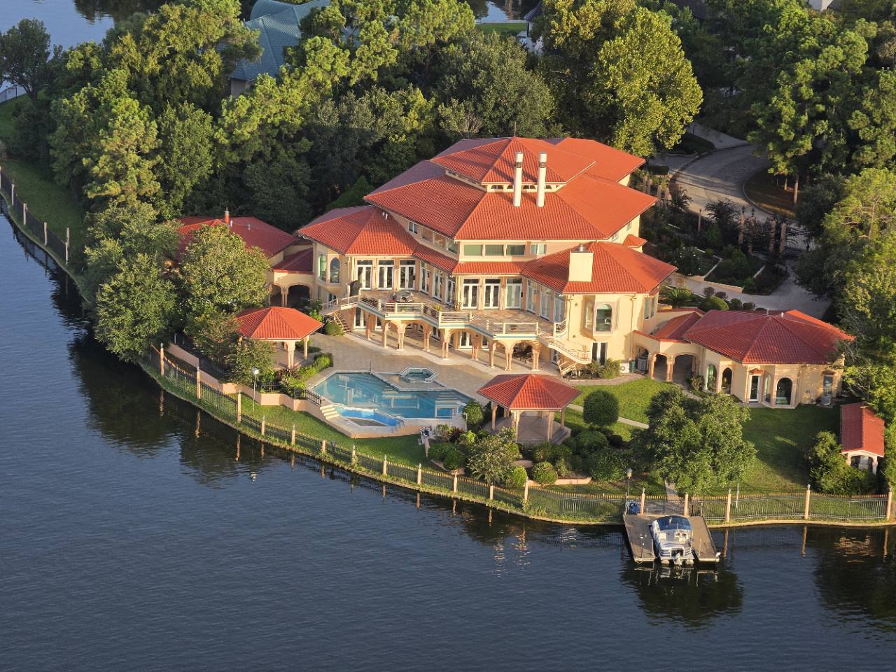 Aerial view of a distinctive waterfront estate in The Woodlands area